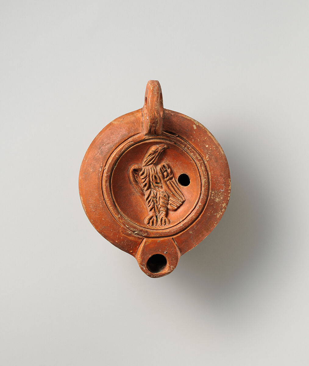Roman terracotta lamp with an eagle in relief on its upper surface