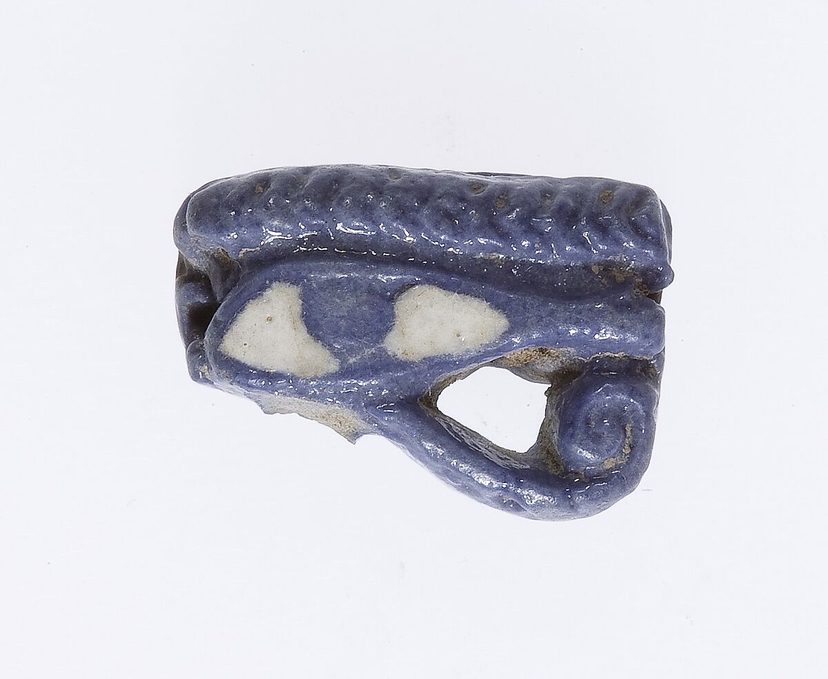Blue faience wedjat eye amulet from ancient Egypt.