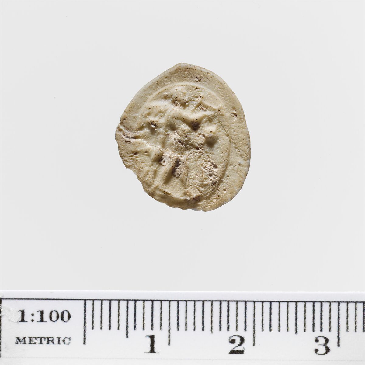 White glass cameo depicting Apollo playing the lyre with a mantle behind Him.