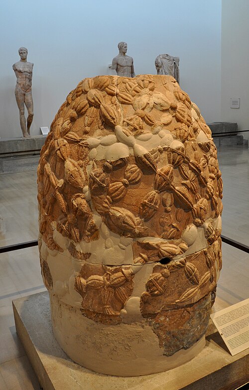 Carved marble omphalos covered with a relief pattern of crossing bands in the Delphi museum