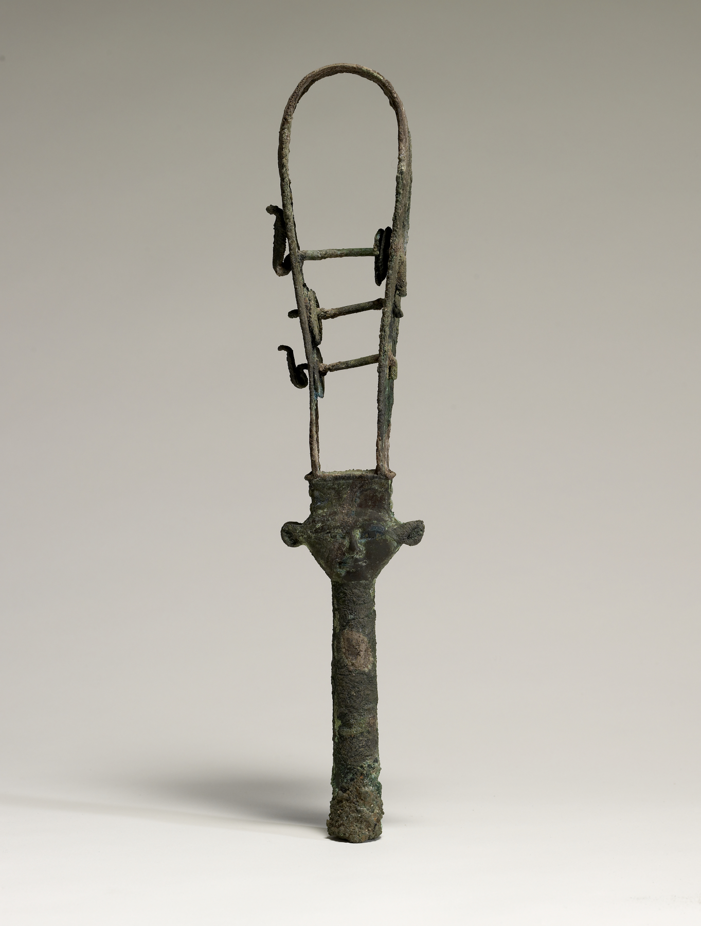 Complete bronze sistrum with a loop-shaped frame, three crossbars and Hathor's head above the long handle.