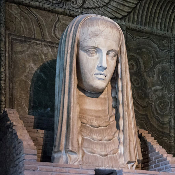 A colossal veiled marble head of the Goddess in a shrine