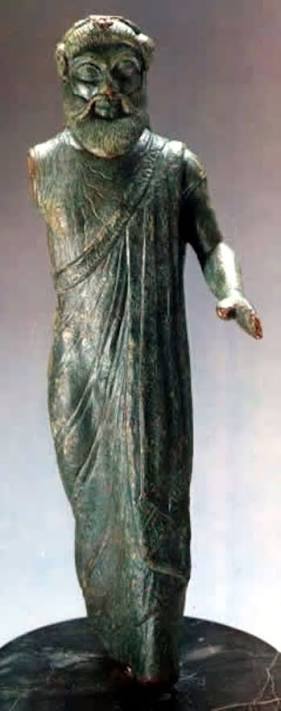 An Etruscan bronze statuette of a bearded God in a mantle