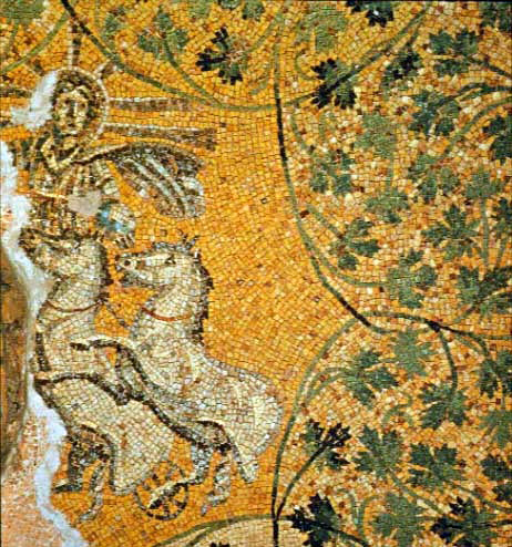 A gold mosaic of a radiate figure driving a chariot drawn by white horses, set among green vine tendrils.