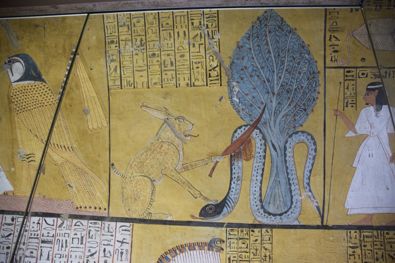 Egyptian tomb wall painting of a cat holding a knife against a large serpent.