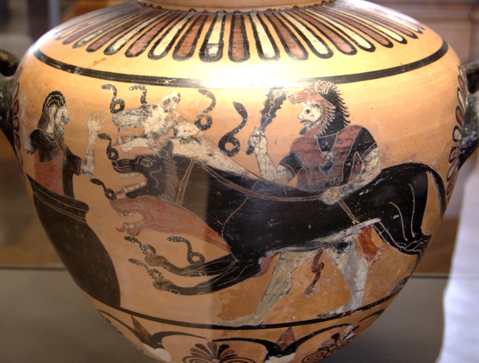 Black-figure vase painting: Heracles leads a 3-headed dog with snakes on its body toward a king hiding in a large jar.
