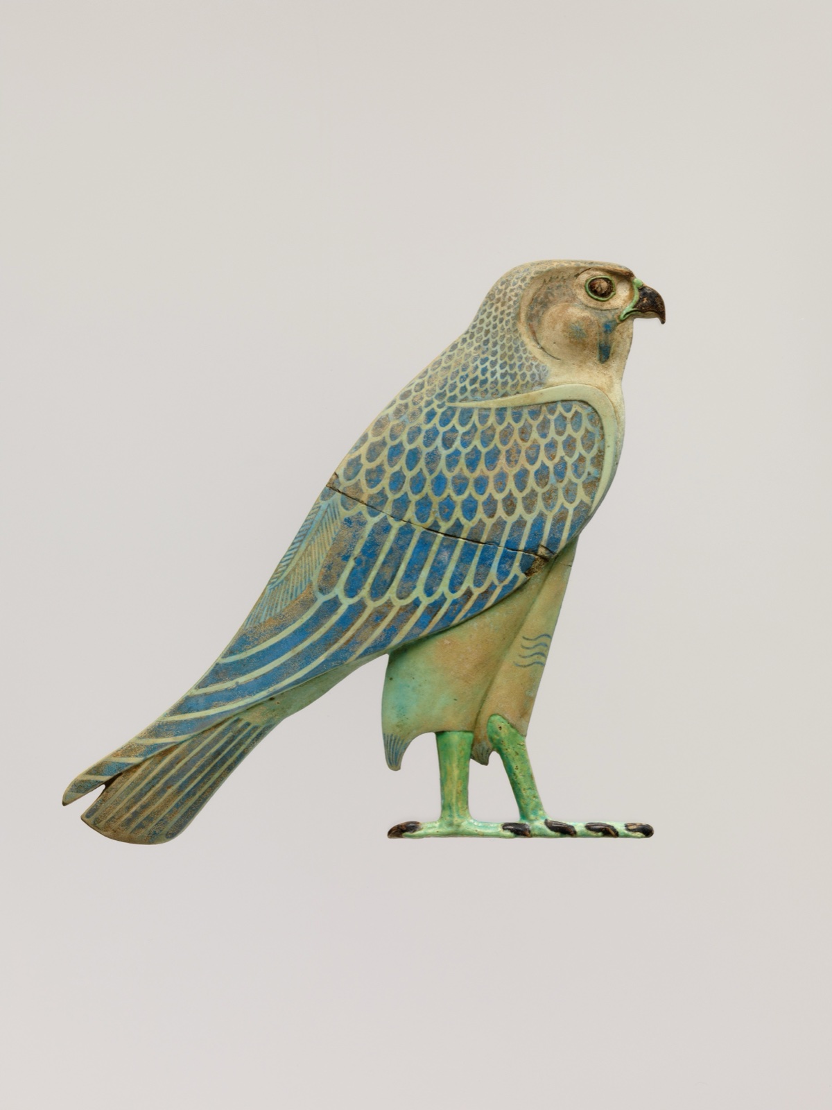 Faience inlay in the shape of a falcon in profile.