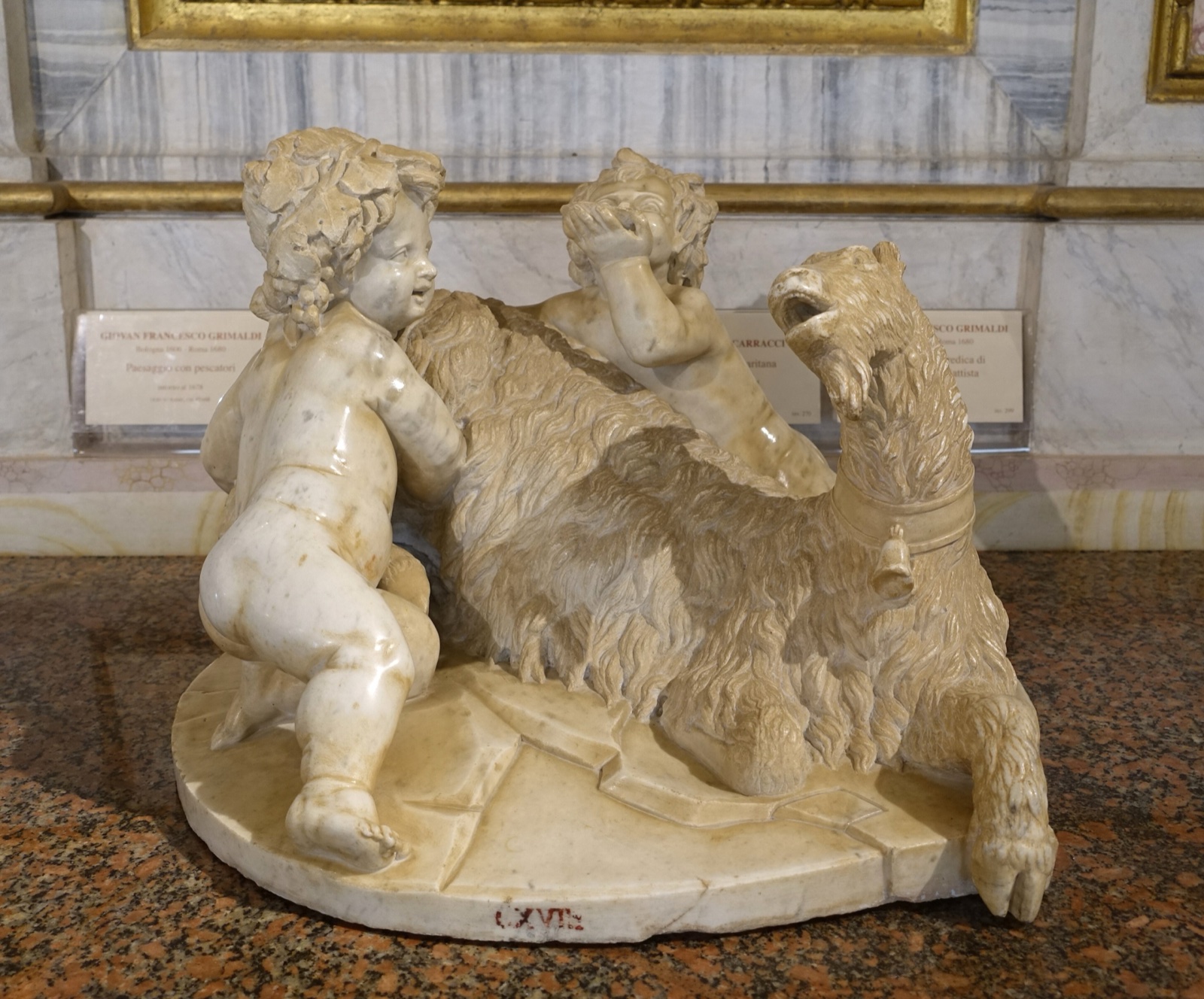 Small marble group of the goat Amalthea with the infant Jupiter and a young faun beside her.