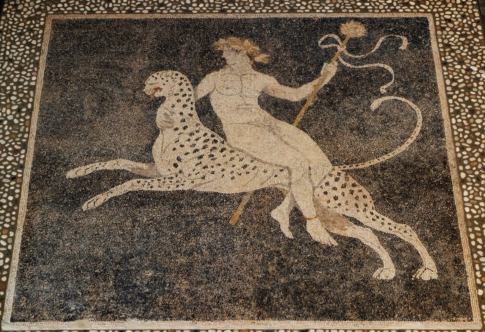 Pebble mosaic of the young Dionysos riding on the back of a panther.